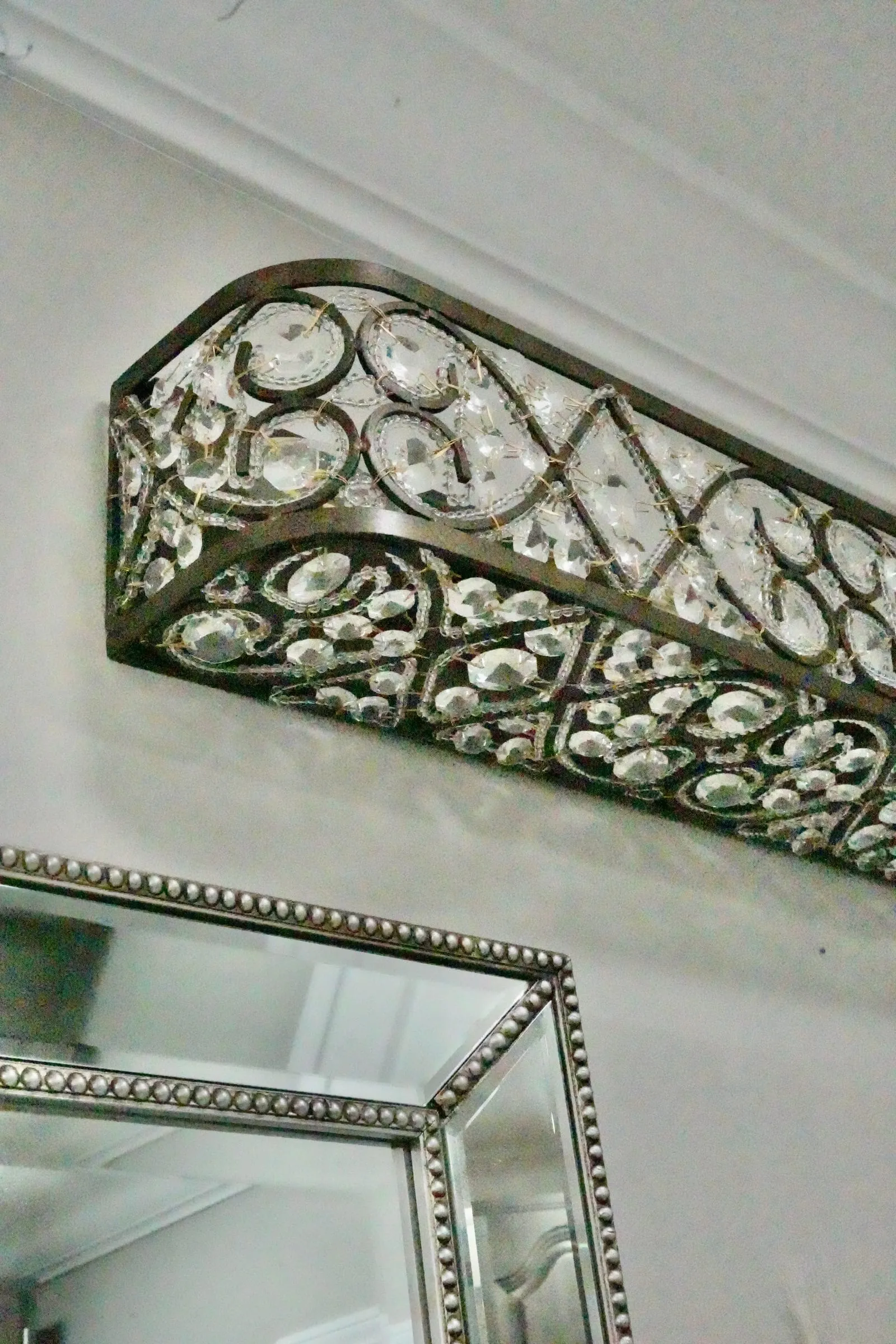 Beaded accents on wall mirrors and vanity lighting