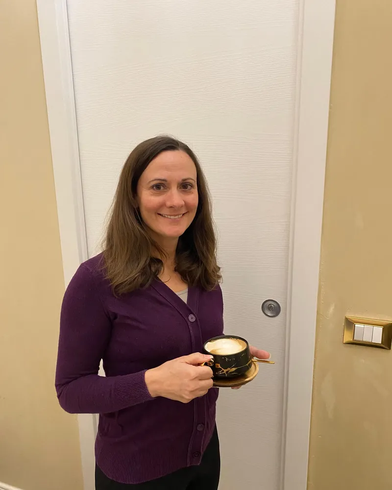 Jessica holding a cup of coffee