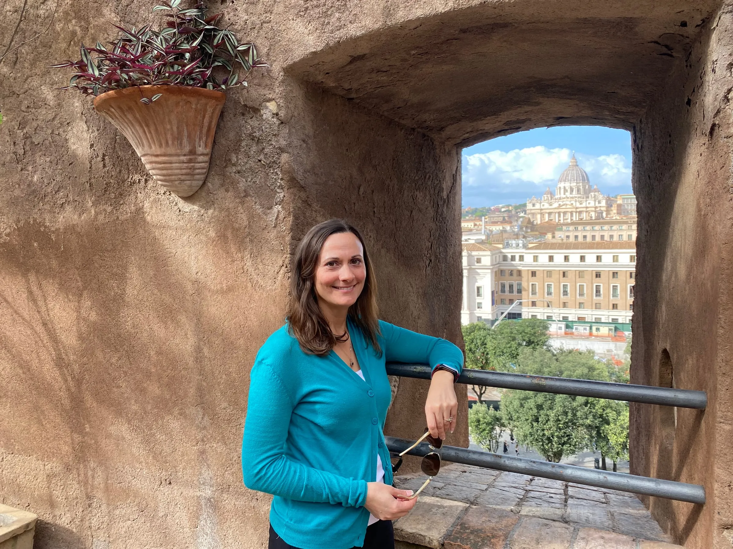 Jessica in a teal cardigan, St. Peter’s Basilica behind her