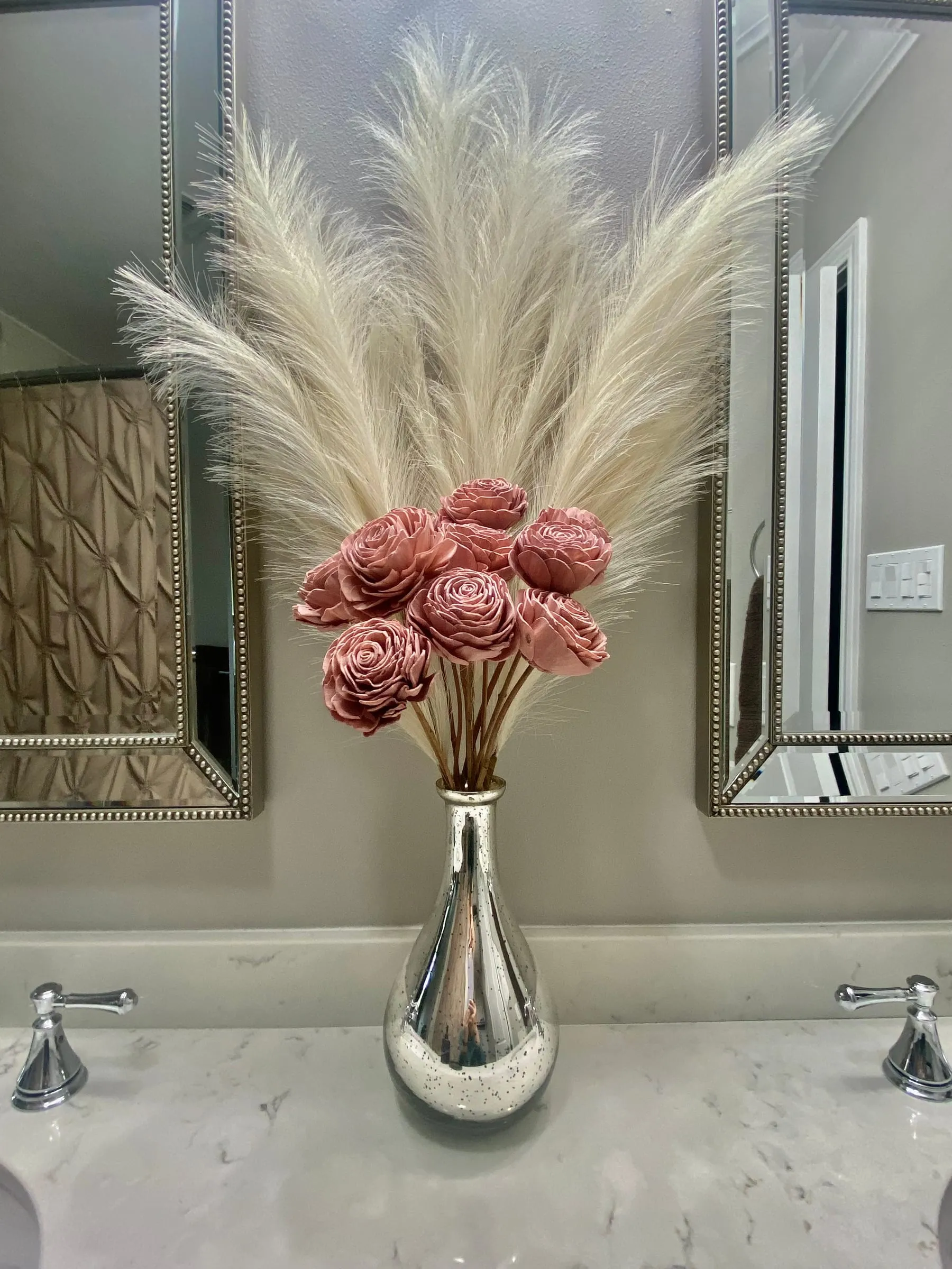Roses and feathers in a mercury glass vase